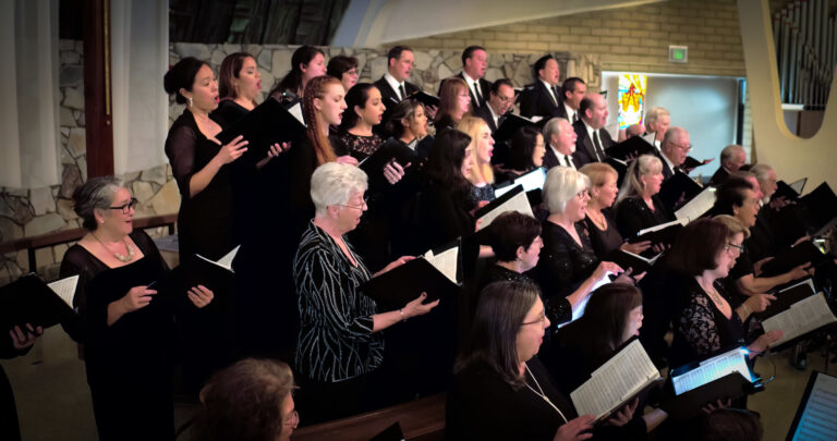 singers in black at a concert.