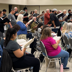 Seated and standing singers singing Carmina Burana.