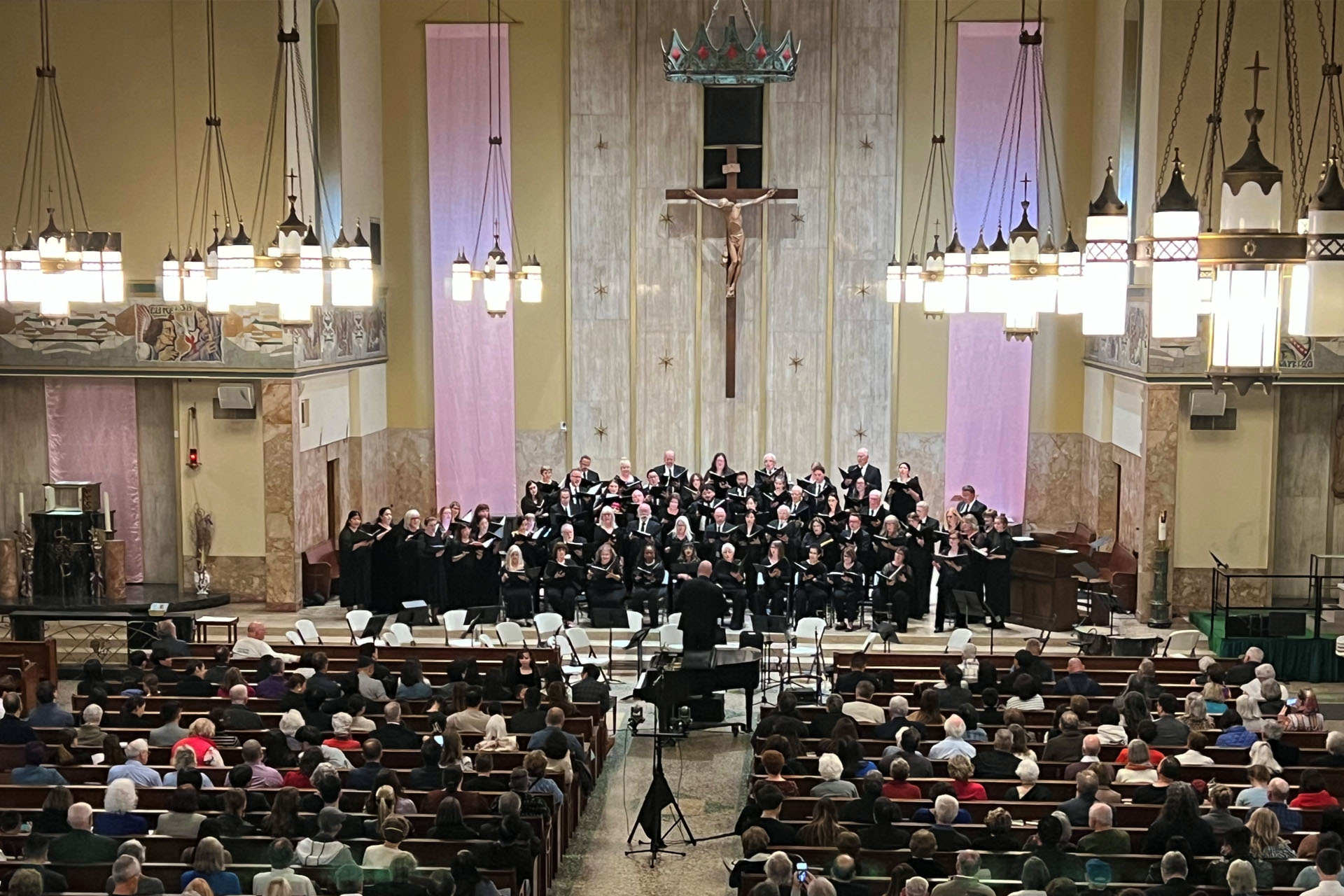 Large choir sings from the alter of a Catholic Church